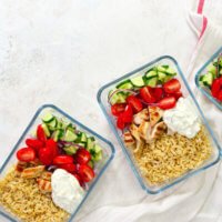 Meal prepping food—like this Greek chicken dish—ahead of time and storing it in reusable containers can help save you time, money, and stress.