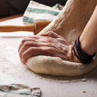 Xanthan gum can add elasticity to gluten-free baked goods, like this dough being kneaded.