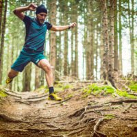 Ancestral health means eating, living, and moving like Paleo hunter–gatherers—like this man is doing during an intense trail run.